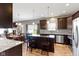 Modern kitchen featuring dark cabinetry, stainless steel appliances, and a large island with seating at 4638 W Otway Ln, New Palestine, IN 46163