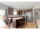 Stylish kitchen featuring dark cabinets, stainless steel appliances, granite counters, and island seating at 4638 W Otway Ln, New Palestine, IN 46163