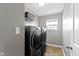 Laundry room with modern, front-load washer and dryer at 4638 W Otway Ln, New Palestine, IN 46163
