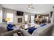 Open-concept living area with hardwood floors, fireplace, and direct access to the kitchen and dining area at 4638 W Otway Ln, New Palestine, IN 46163