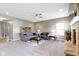 Spacious living room featuring neutral walls, fireplace, ceiling fan, and comfortable gray couches at 4638 W Otway Ln, New Palestine, IN 46163