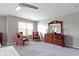 Bedroom with neutral colors, ceiling fan and two sitting chairs at 4638 W Otway Ln, New Palestine, IN 46163