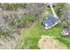 An aerial view showcasing the property's layout and generous green surroundings, including a fire pit and deck at 5302 E 46Th St, Indianapolis, IN 46226
