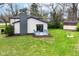 This home offers a cozy backyard with a gray deck, perfect for enjoying the outdoors, and a fire pit area at 5302 E 46Th St, Indianapolis, IN 46226