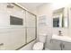 Modern bathroom features a shower over bath with glass screen, updated tiles and a stylish vanity at 5302 E 46Th St, Indianapolis, IN 46226