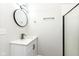 Clean bathroom features modern vanity, updated lighting, and a tiled shower with glass door at 5302 E 46Th St, Indianapolis, IN 46226