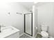 Updated bathroom features a tiled shower with glass door, modern vanity and fixtures at 5302 E 46Th St, Indianapolis, IN 46226