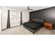 This bedroom features a modern accent wall, ceiling fan and two side tables at 5302 E 46Th St, Indianapolis, IN 46226
