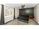 This bedroom features a modern accent wall, ceiling fan and a large window at 5302 E 46Th St, Indianapolis, IN 46226