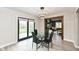 Dining area featuring modern lighting, an open layout, and sliding glass doors providing natural light and backyard views at 5302 E 46Th St, Indianapolis, IN 46226