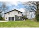 Home featuring a two-car garage, complimented by a green lawn and mature trees at 5302 E 46Th St, Indianapolis, IN 46226