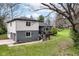 Two-story home showcasing gray brick and vinyl siding, accented by a spacious driveway and mature trees at 5302 E 46Th St, Indianapolis, IN 46226