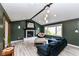 Living room featuring vaulted ceilings, modern lighting, and a fireplace at 5302 E 46Th St, Indianapolis, IN 46226