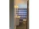 Compact bathroom with a modern vanity, mirror, and blue-striped shower curtain at 5428 Speedway Dr, Indianapolis, IN 46224