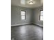 Cozy bedroom featuring vinyl floors and two windows for plenty of natural light at 5428 Speedway Dr, Indianapolis, IN 46224
