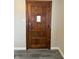 Classic wooden front door with a paneled design and vintage hardware at 5428 Speedway Dr, Indianapolis, IN 46224