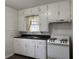 Functional kitchen with classic white cabinets, a double basin sink, and a range at 5428 Speedway Dr, Indianapolis, IN 46224