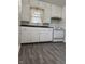 Functional kitchen featuring vinyl floors, white cabinets, double basin sink and range at 5428 Speedway Dr, Indianapolis, IN 46224