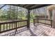 Charming back porch with wooden deck and railings overlooks the spacious, tree-lined backyard at 5461 Steven Dr, Greenwood, IN 46142
