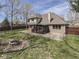 Yard with stone fire pit features a home with a deck and a gazebo in a fenced lot at 5461 Steven Dr, Greenwood, IN 46142