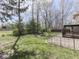 Expansive backyard featuring a fire pit, open lawn, and a partially fenced perimeter at 5461 Steven Dr, Greenwood, IN 46142