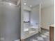Bathroom featuring a walk-in shower, jacuzzi tub, and modern flooring at 5461 Steven Dr, Greenwood, IN 46142