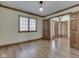 Bedroom with hardwood floors, wood trim, and large window at 5461 Steven Dr, Greenwood, IN 46142