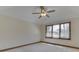 Bedroom with carpet, ceiling fan, and window overlooking the yard at 5461 Steven Dr, Greenwood, IN 46142