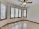 Well-lit bedroom with hardwood floors, ceiling fan and three large windows at 5461 Steven Dr, Greenwood, IN 46142
