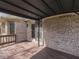 Covered wood deck showing brick wall, a sliding glass door, and view of the backyard at 5461 Steven Dr, Greenwood, IN 46142
