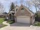 A view of a brick home featuring an attached garage and well-maintained lawn at 5461 Steven Dr, Greenwood, IN 46142