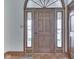 Elegant wooden front door with side windows and stylish transom window at 5461 Steven Dr, Greenwood, IN 46142