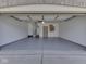 Spacious, clean garage with neutral walls, gray flooring and a doorway at the back at 5461 Steven Dr, Greenwood, IN 46142