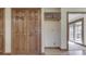 Hallway with paneled wood doors, upper cabinet, and view to deck at 5461 Steven Dr, Greenwood, IN 46142