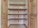Interior view of a pantry with multiple wooden shelves at 5461 Steven Dr, Greenwood, IN 46142