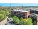 Brick exterior of the H. Lauter Lofts, featuring private balconies and a visible parking lot at 55 S Harding St # 301, Indianapolis, IN 46222