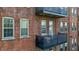 Brick apartment building featuring iron balconies with outdoor seating and large windows providing natural light at 55 S Harding St # 301, Indianapolis, IN 46222