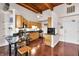 Well-lit kitchen with stainless steel appliances, granite countertops and wood-beamed ceilings at 55 S Harding St # 301, Indianapolis, IN 46222