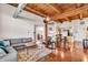 Open concept living room leading into kitchen with natural light and wood-beamed ceilings at 55 S Harding St # 301, Indianapolis, IN 46222