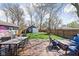 Beautiful backyard with wooden deck, outdoor seating, green lawn, and storage shed at 5619 Carrollton Ave, Indianapolis, IN 46220
