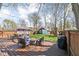 Spacious backyard featuring deck with outdoor seating, fire pit, and a lush green lawn at 5619 Carrollton Ave, Indianapolis, IN 46220