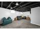 Finished basement area with exposed ceiling, gray carpet and plenty of room for relaxing at 5619 Carrollton Ave, Indianapolis, IN 46220