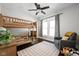 Cozy ' bedroom with wood bunk beds, area rug, ceiling fan, and natural light at 5619 Carrollton Ave, Indianapolis, IN 46220