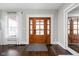 Beautiful foyer with a stunning wood front door and matching hardwood floors at 5619 Carrollton Ave, Indianapolis, IN 46220