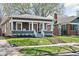 A quaint single Gathering home shows fresh landscaping, inviting front porch, and mature trees at 5619 Carrollton Ave, Indianapolis, IN 46220