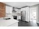 Well-appointed kitchen featuring stainless steel appliances, white cabinetry, and a stylish subway tile backsplash at 5619 Carrollton Ave, Indianapolis, IN 46220
