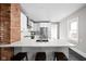Bright kitchen showcasing a large island with seating, white cabinetry, subway tile backsplash, and modern appliances at 5619 Carrollton Ave, Indianapolis, IN 46220