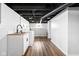 Well-lit laundry room with white cabinets, sink, butcher block countertop, and modern appliances at 5619 Carrollton Ave, Indianapolis, IN 46220
