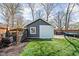 Backyard shed with a white door and trim, siding, and a small window at 5619 Carrollton Ave, Indianapolis, IN 46220