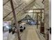 Unfinished attic space with wooden beams, insulation, and visible storage solutions at 57 Worman St, Indianapolis, IN 46227